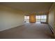 Spacious living room with neutral carpeting, large windows, and an inviting space for relaxation and entertainment at 3131 E Alameda Ave # 1604, Denver, CO 80209