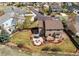 A sprawling backyard with a stone patio, a fire pit, a dining set, and a lush lawn at 1678 S Parkdale Cir, Erie, CO 80516