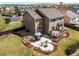 A spacious backyard featuring a patio with a dining set, a fire pit, and a well-manicured garden at 1678 S Parkdale Cir, Erie, CO 80516