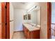 Bathroom featuring a large vanity with mirror and updated lighting at 1678 S Parkdale Cir, Erie, CO 80516