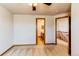 Bedroom featuring neutral carpet, ceiling fan, and doorway to ensuite bathroom and upper hallway at 1678 S Parkdale Cir, Erie, CO 80516
