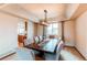 Elegant dining room featuring modern chandelier, large table with seating, and a pass-through to kitchen at 1678 S Parkdale Cir, Erie, CO 80516