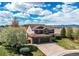 Lovely exterior with a three-car garage, a covered front porch, a well-kept lawn, and mature trees at 1678 S Parkdale Cir, Erie, CO 80516