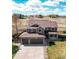 Stunning home with a three-car garage, a covered front porch, and a well-maintained lawn at 1678 S Parkdale Cir, Erie, CO 80516