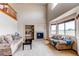 Cozy living room with a fireplace, built-in shelving, and comfortable seating with an open view at 1678 S Parkdale Cir, Erie, CO 80516