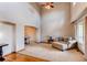 Bright living room boasting soaring ceilings, hardwood floors, and an arched entryway to the dining room at 1678 S Parkdale Cir, Erie, CO 80516