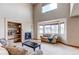 Inviting living room showcasing a fireplace, built-in shelving, plush seating, and large windows at 1678 S Parkdale Cir, Erie, CO 80516