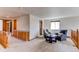 Spacious loft area with two armchairs, built in cabinet, and natural light from a window at 1678 S Parkdale Cir, Erie, CO 80516