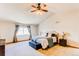 Bright and spacious main bedroom with vaulted ceiling, large window, and a cozy sitting area at 1678 S Parkdale Cir, Erie, CO 80516