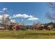 A modern playground area with colorful equipment under a clear blue sky at 1678 S Parkdale Cir, Erie, CO 80516
