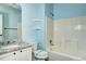 Bathroom with granite countertop vanity and white tiled shower and bath at 152 Pelican Ave, Brighton, CO 80601