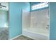 Full bathroom with white tiled tub and shower at 152 Pelican Ave, Brighton, CO 80601
