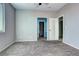 Bedroom with neutral walls and carpet, showing two entries to a bathroom and closet at 152 Pelican Ave, Brighton, CO 80601