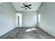 Carpeted bedroom featuring a ceiling fan, ample natural light, and neutral walls at 152 Pelican Ave, Brighton, CO 80601