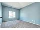 Bedroom featuring carpet flooring, a large window, and neutral walls at 152 Pelican Ave, Brighton, CO 80601