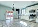 Modern kitchen featuring tile flooring, stainless steel appliances, and sliding glass doors at 152 Pelican Ave, Brighton, CO 80601