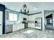 Bright kitchen featuring stainless steel appliances, tile backsplash, and a decorative chandelier at 152 Pelican Ave, Brighton, CO 80601