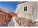Side yard with concrete path and a planting area, perfect for gardening at 152 Pelican Ave, Brighton, CO 80601