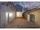 Wide stone patio between two houses, featuring a backdoor entrance, a fence, and exterior utilities at 2550 Xanthia Ct, Denver, CO 80238
