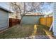Fenced backyard with a tree and grass at 2550 Xanthia Ct, Denver, CO 80238