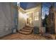 Backyard patio area with stone tiles, steps leading to a sliding door, and the home's exterior at 2550 Xanthia Ct, Denver, CO 80238