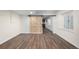 Finished basement with sliding barn door, recessed lighting, laminate floors and a wet bar at 2550 Xanthia Ct, Denver, CO 80238
