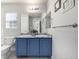 Bathroom featuring a blue double vanity, granite countertops and a large mirror with contemporary lighting at 2550 Xanthia Ct, Denver, CO 80238