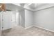 Bright, carpeted bedroom with white trim and walls, featuring a ceiling fan and access to an adjoining room at 2550 Xanthia Ct, Denver, CO 80238