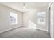 Bedroom featuring neutral carpet and walls, a ceiling fan and two windows with blinds and bright natural light at 2550 Xanthia Ct, Denver, CO 80238