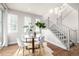 Bright dining area with a glass table, white chairs, and hardwood floors at 2550 Xanthia Ct, Denver, CO 80238