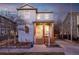 Charming two-story home featuring a welcoming front porch with wooden pillars and a well-maintained yard at 2550 Xanthia Ct, Denver, CO 80238