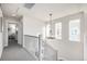Hallway with carpeted floors, chandelier, and natural light from the windows at 2550 Xanthia Ct, Denver, CO 80238