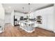 Stylish kitchen featuring white cabinets, granite countertops, stainless steel appliances, and a central island at 2550 Xanthia Ct, Denver, CO 80238