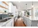 Open-concept kitchen with granite countertops, stainless steel appliances, and view into the living room at 2550 Xanthia Ct, Denver, CO 80238