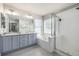 Luxury bath with a soaking tub, glass shower, double vanity, and tile floors for a spa-like experience at 2550 Xanthia Ct, Denver, CO 80238