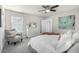 Inviting bedroom features a plush bed, soft carpet, and a cozy seating area near the window at 2550 Xanthia Ct, Denver, CO 80238