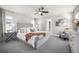 Spacious bedroom featuring a tufted headboard bed, modern ceiling fan, and natural light for a relaxing retreat at 2550 Xanthia Ct, Denver, CO 80238