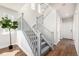 Staircase with gray banisters and carpeted steps, next to a potted plant at 2550 Xanthia Ct, Denver, CO 80238
