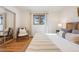 Bright bedroom with neutral walls, natural light, and mirrored closet, maximizing space and style at 2001 Grove St, Denver, CO 80211
