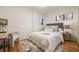 Bright bedroom with a gray headboard, a desk area, and natural light for a cozy and productive space at 2001 Grove St, Denver, CO 80211