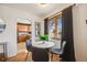 Charming dining area with a round table, stylish chairs, and view into the modern kitchen at 2001 Grove St, Denver, CO 80211