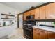 Spacious kitchen with stainless steel appliances, wood cabinets, and a door leading outside at 2001 Grove St, Denver, CO 80211