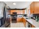 Modern kitchen with stainless steel appliances, sleek countertops, and stylish wood cabinetry at 2001 Grove St, Denver, CO 80211