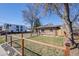 View of home with fenced yard featuring a tidy lawn and mature trees at 2001 Grove St, Denver, CO 80211