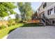 View of manicured lawn with concrete patio and mature trees, perfect for outdoor gatherings at 15963 Rock Crystal Dr, Parker, CO 80134