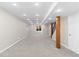 A finished basement featuring neutral carpet, recessed lights, and wooden support beam at 15963 Rock Crystal Dr, Parker, CO 80134
