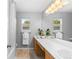 Bathroom with double sink vanity, lots of light, and combined tub and shower at 15963 Rock Crystal Dr, Parker, CO 80134