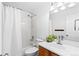 Bright bathroom with shower/tub combination and a sink with a wooden cabinet at 15963 Rock Crystal Dr, Parker, CO 80134