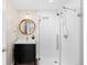 Stylish bathroom featuring a sleek glass-enclosed shower and modern vanity with copper-trimmed mirror at 15963 Rock Crystal Dr, Parker, CO 80134