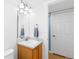 Cozy bathroom showcasing a wood vanity with a bright mirror and ample lighting at 15963 Rock Crystal Dr, Parker, CO 80134
